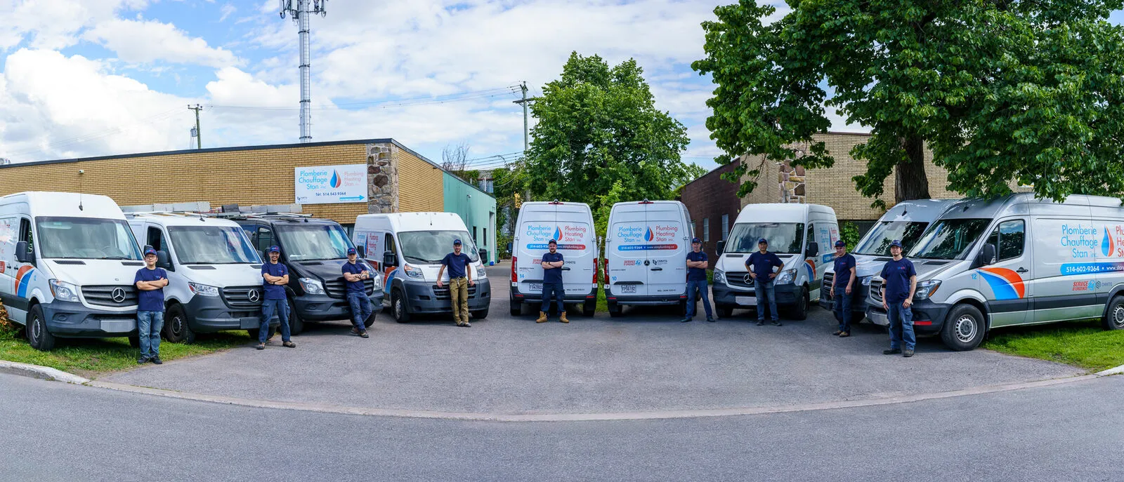 The Plomberie Chauffage Stan crew with the company vans